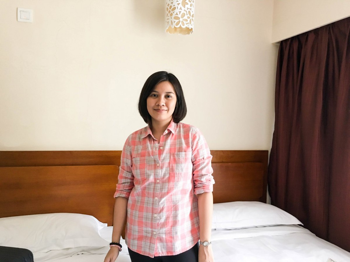 Woman in front of twin beds