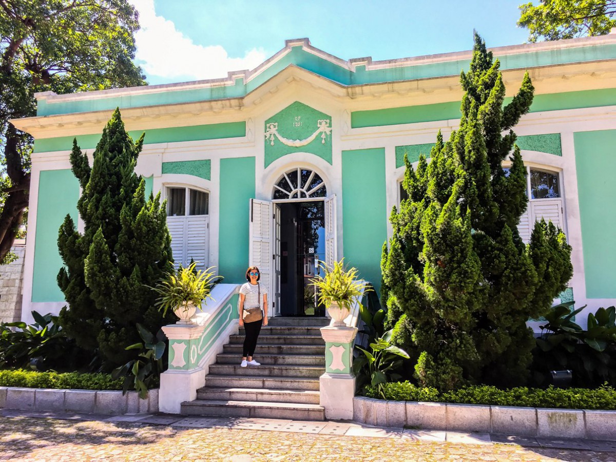 The writer posing in front of one of the house museums.